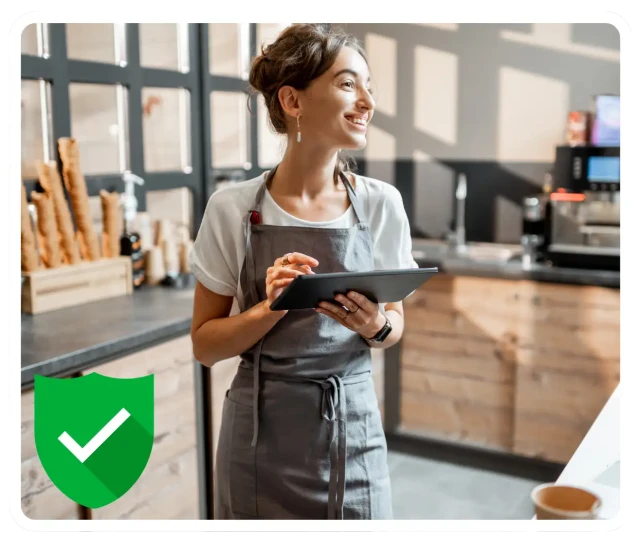 Cafe worker using RosterElf auto-scheduling on tablet