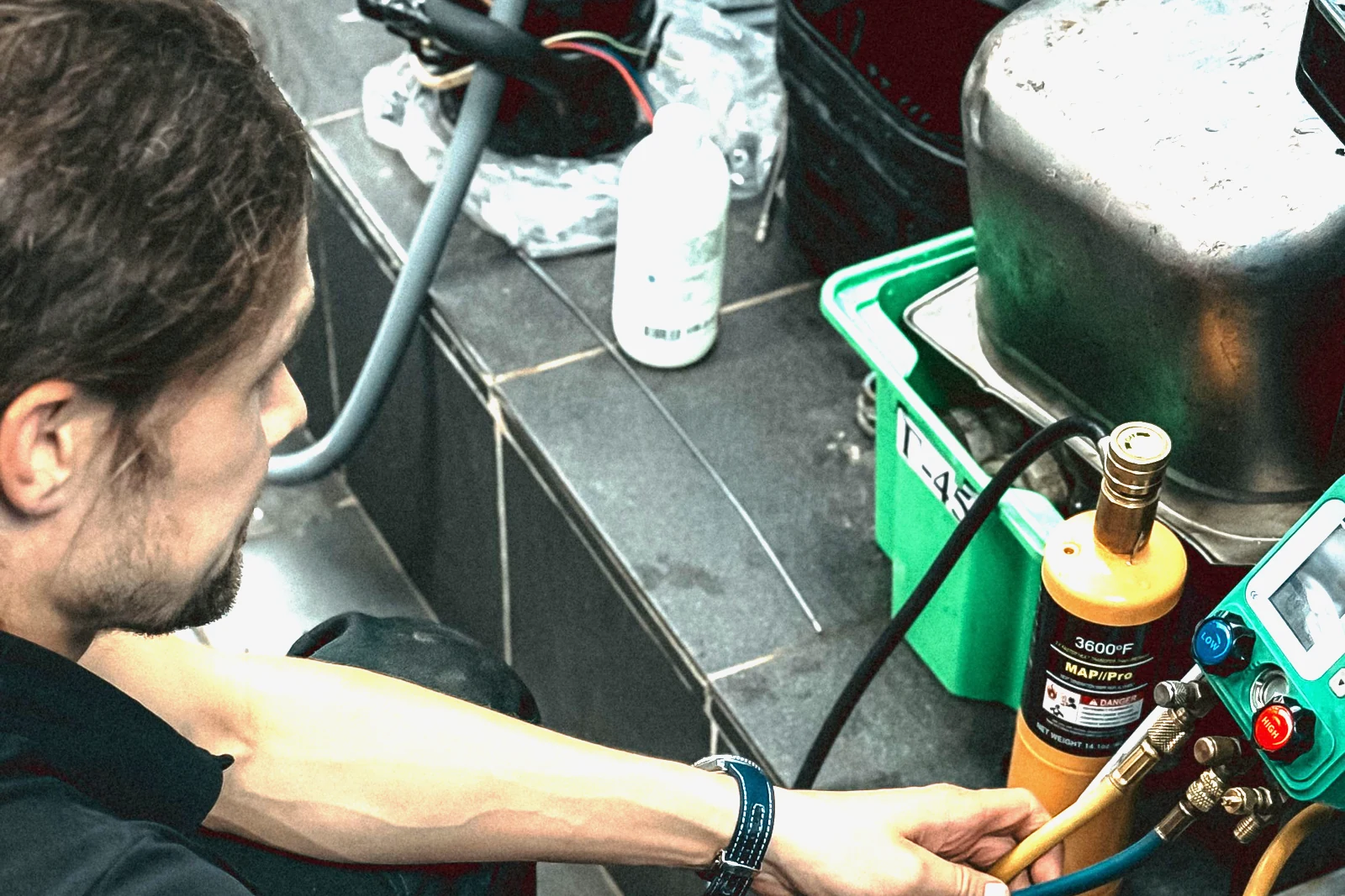 A gas technician checking the gauges on pressurised cylinders