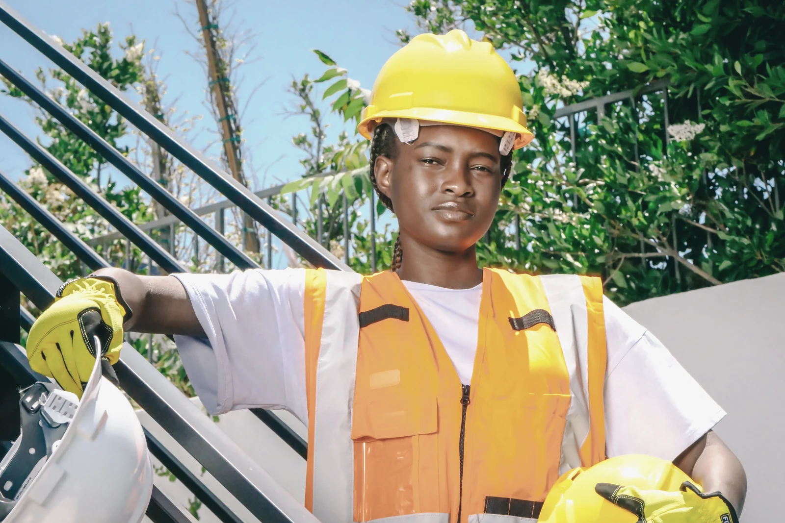 A mine worker in a hard hat, safety glasses and hi-vis on site
