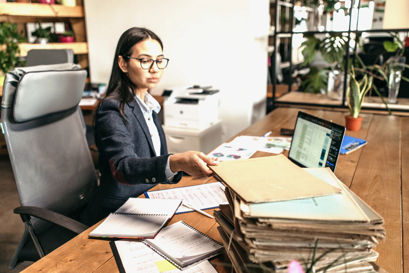 An office administrator working through paperwork at her desk