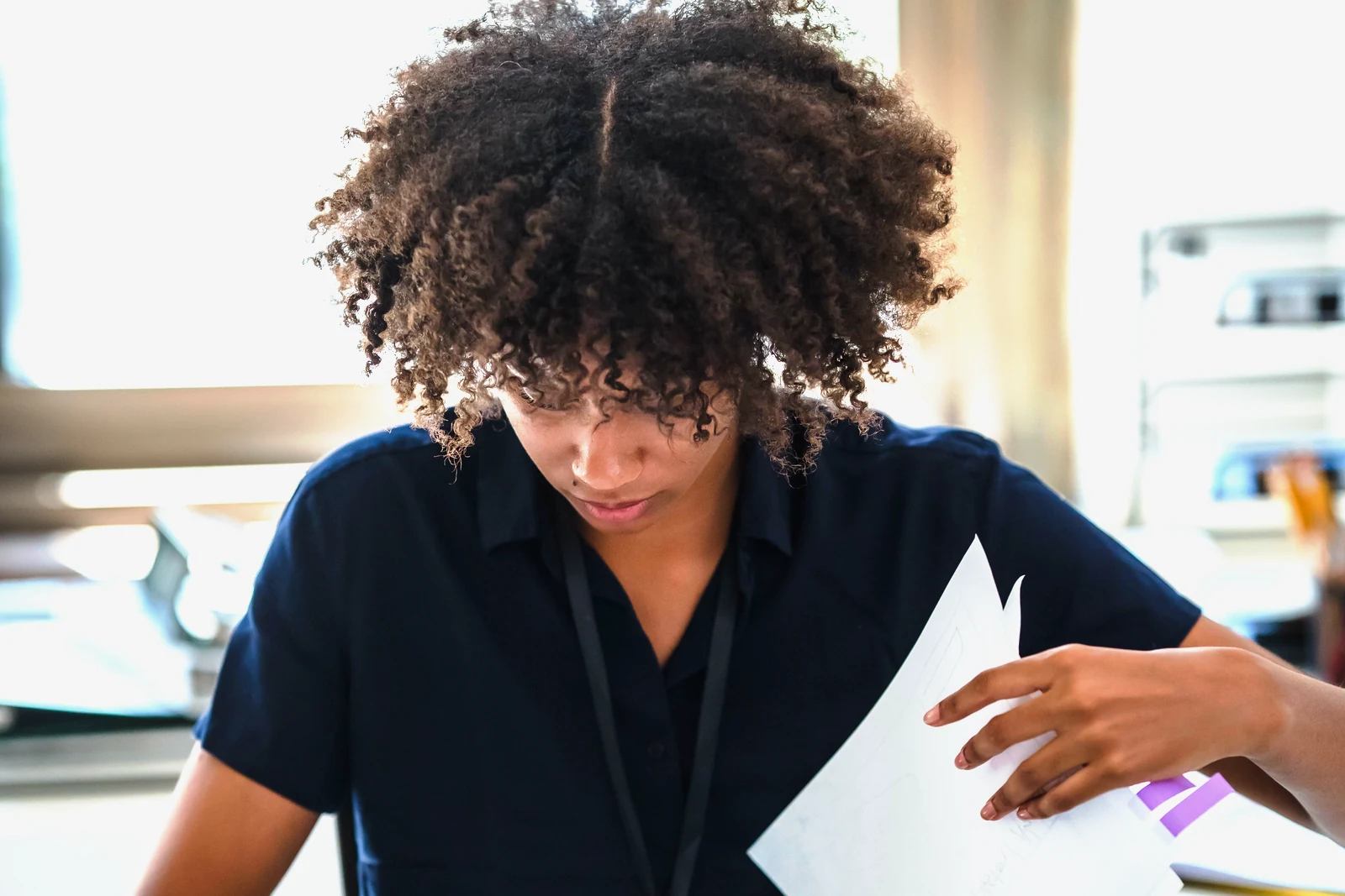 An administrator sorting documents in an office