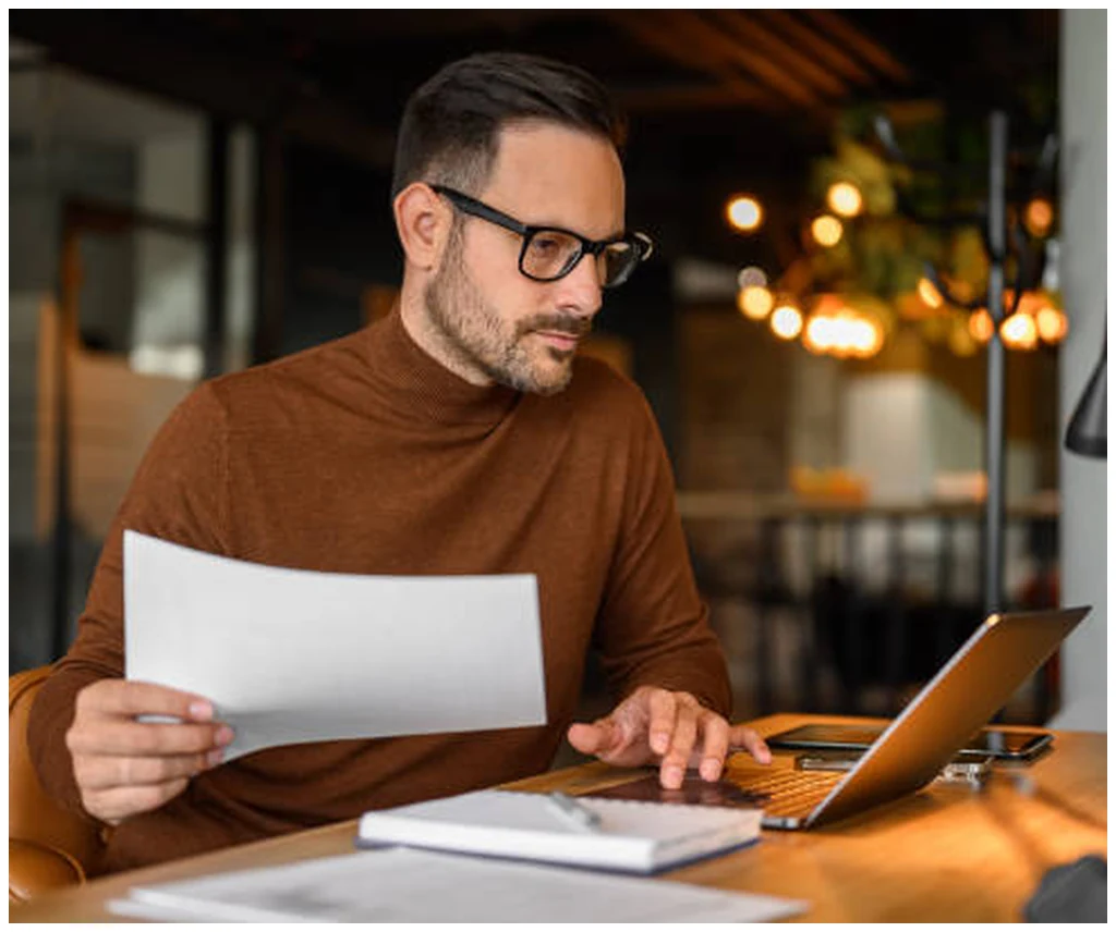 Manager reviewing performance reports and summaries at a desk