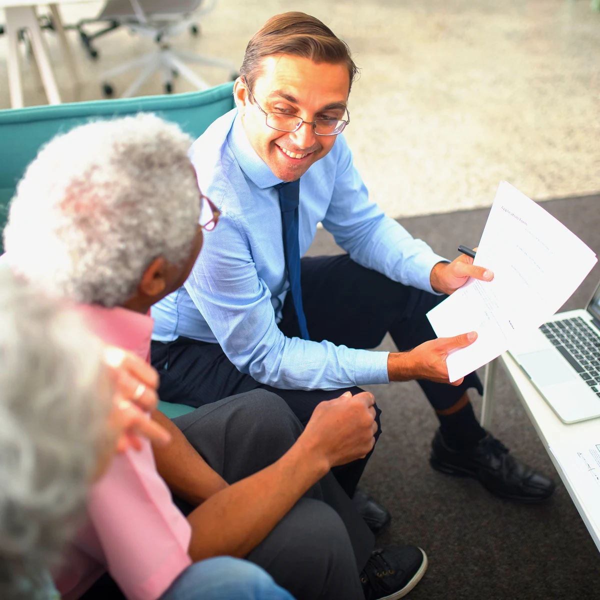 An accountant going through documents with clients in a Canberra office