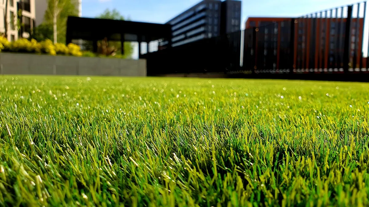 Grounds maintenance worker mowing lawn